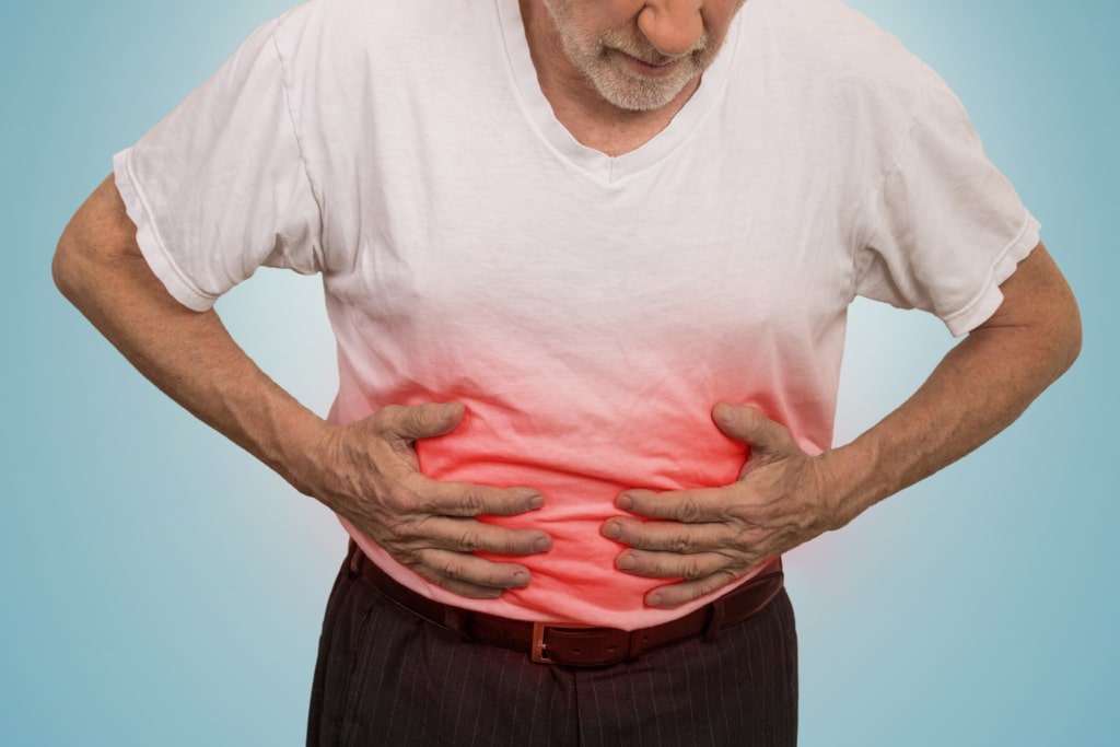 man holding his belly in pain